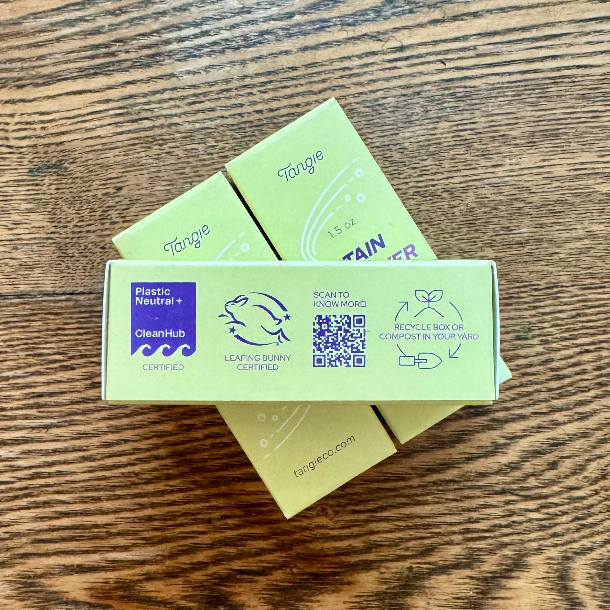 The side panel of a rectangular yellowish box that lists Clean Hub Certified, Leaping Bunny Certified, a QR code linking to more information, and a suggestion to recycle or compost the box when empty.